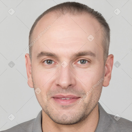 Joyful white adult male with short  brown hair and grey eyes