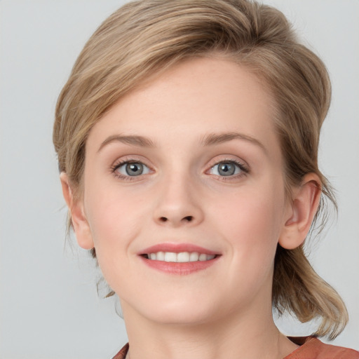 Joyful white young-adult female with medium  brown hair and blue eyes