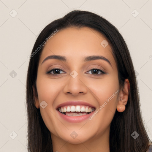 Joyful latino young-adult female with long  black hair and brown eyes