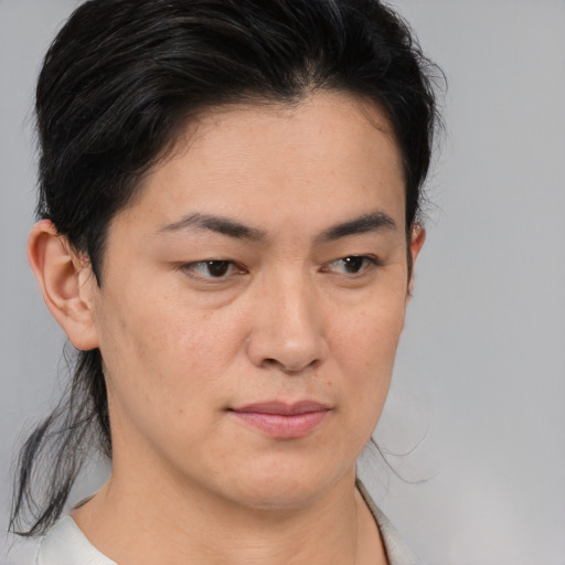 Joyful asian young-adult female with medium  brown hair and brown eyes