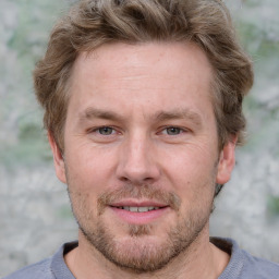 Joyful white adult male with short  brown hair and grey eyes