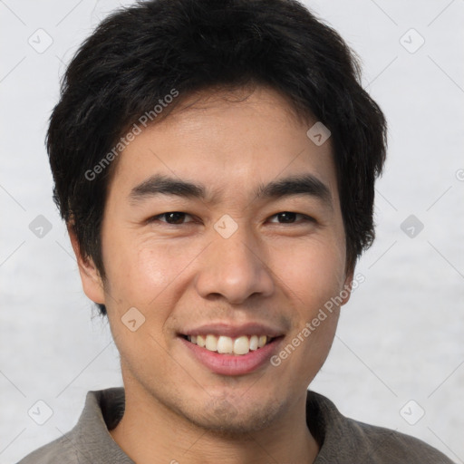 Joyful asian young-adult male with short  brown hair and brown eyes