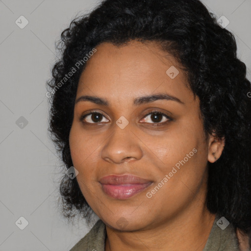 Joyful black young-adult female with long  black hair and brown eyes