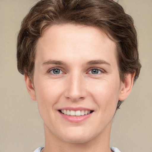 Joyful white young-adult female with short  brown hair and grey eyes