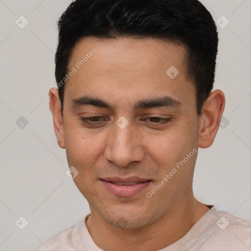 Joyful white young-adult male with short  black hair and brown eyes