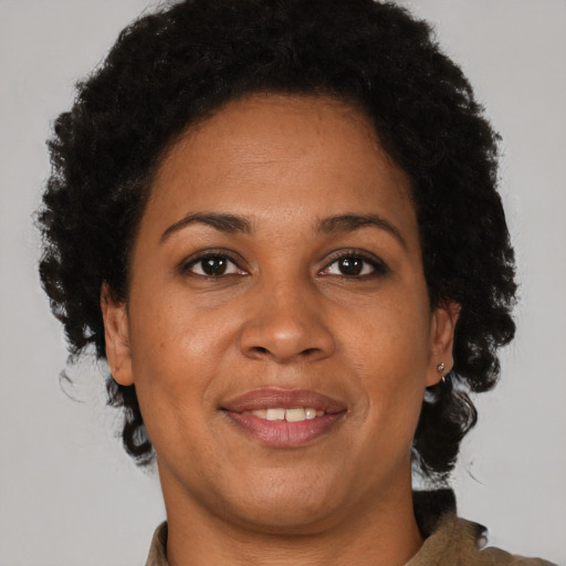 Joyful black adult female with short  brown hair and brown eyes