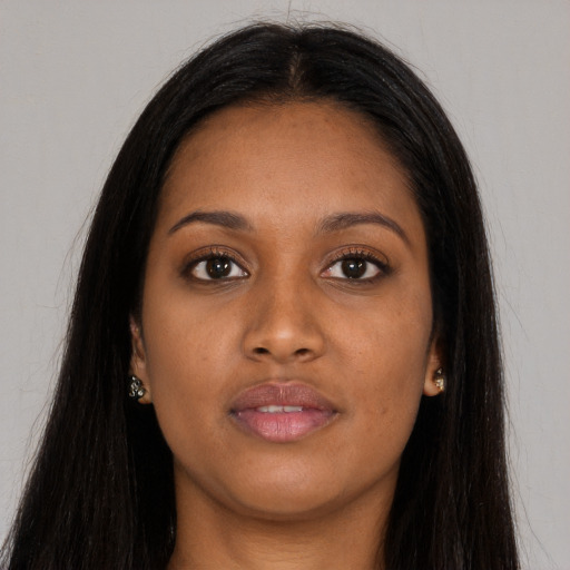 Joyful asian young-adult female with long  brown hair and brown eyes