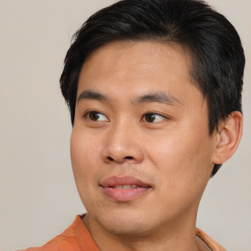 Joyful asian young-adult male with short  brown hair and brown eyes