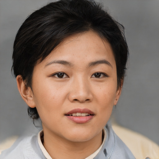 Joyful asian young-adult female with short  brown hair and brown eyes