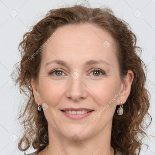 Joyful white adult female with long  brown hair and grey eyes