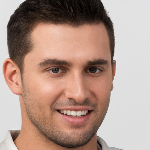 Joyful white young-adult male with short  brown hair and brown eyes