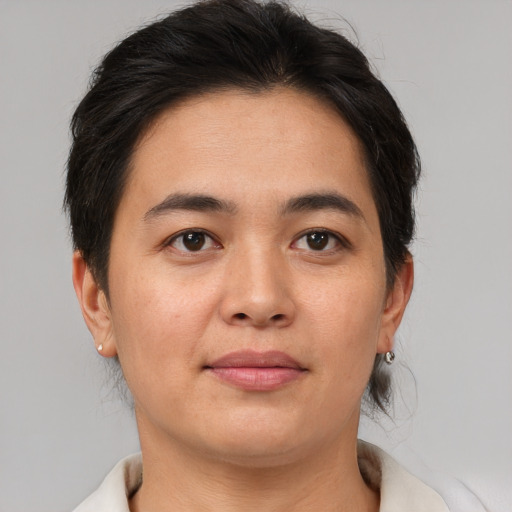 Joyful asian young-adult female with medium  brown hair and brown eyes
