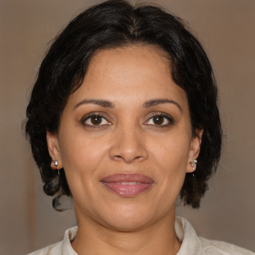 Joyful black young-adult female with medium  brown hair and brown eyes