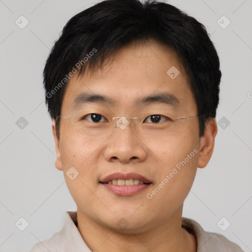 Joyful asian young-adult male with short  brown hair and brown eyes