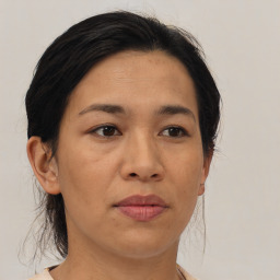 Joyful asian adult female with medium  brown hair and brown eyes