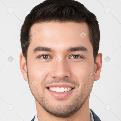 Joyful white young-adult male with short  brown hair and brown eyes