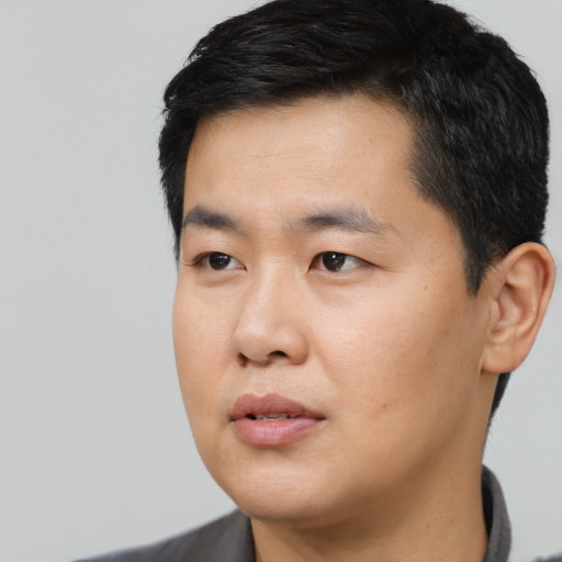 Neutral asian young-adult male with short  black hair and brown eyes