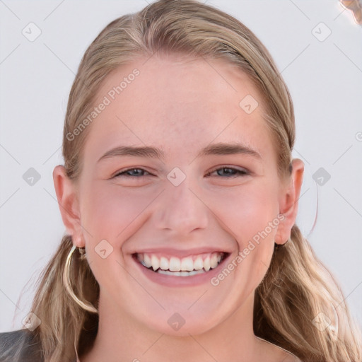 Joyful white young-adult female with long  brown hair and blue eyes