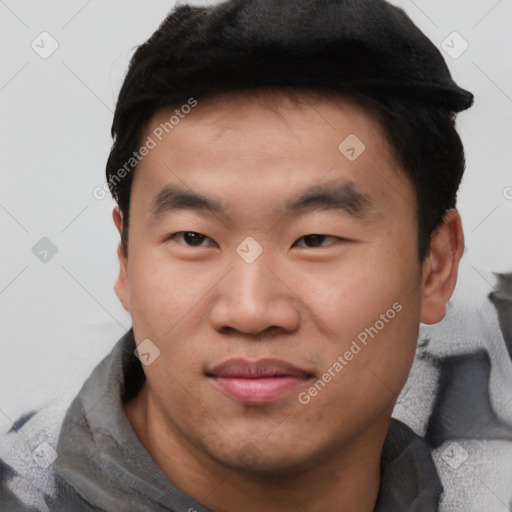 Joyful asian young-adult male with short  brown hair and brown eyes