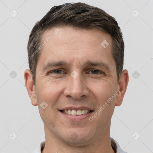 Joyful white adult male with short  brown hair and brown eyes