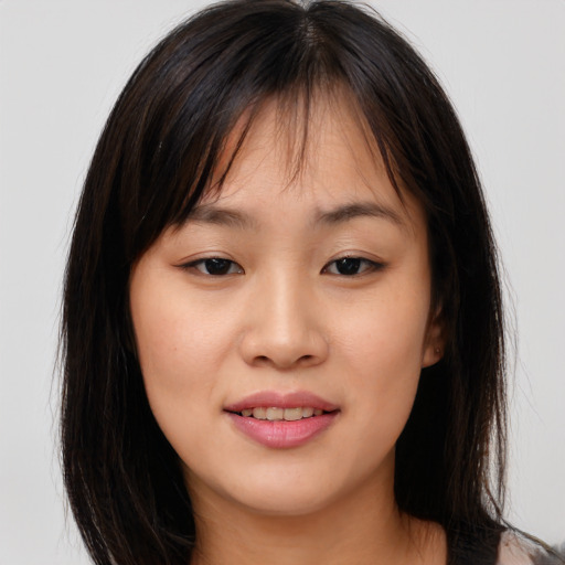 Joyful asian young-adult female with long  brown hair and brown eyes