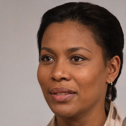 Joyful black young-adult female with medium  brown hair and brown eyes