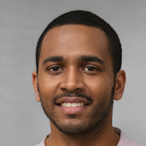 Joyful black young-adult male with short  black hair and brown eyes