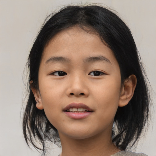 Joyful asian child female with medium  brown hair and brown eyes
