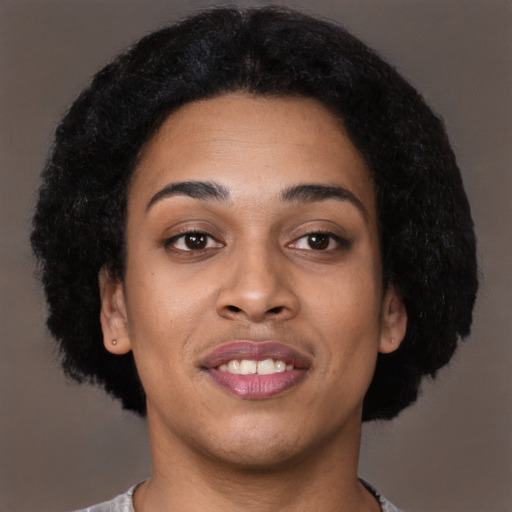 Joyful black young-adult female with short  brown hair and brown eyes
