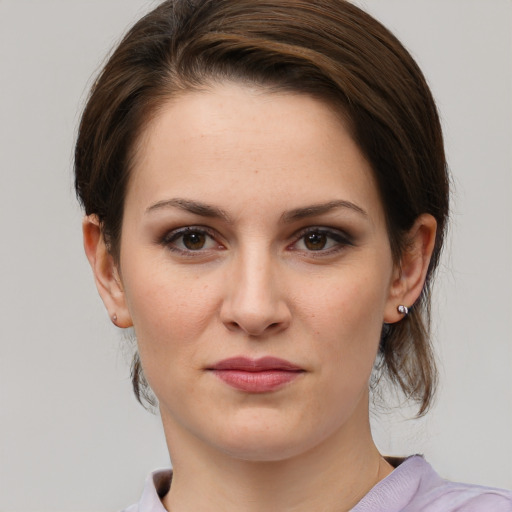 Joyful white young-adult female with medium  brown hair and grey eyes