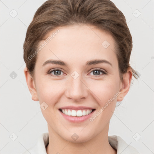 Joyful white young-adult female with short  brown hair and grey eyes