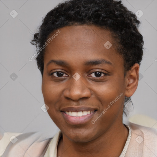 Joyful black young-adult female with short  black hair and brown eyes