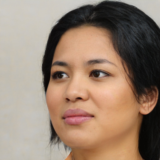 Joyful asian young-adult female with medium  black hair and brown eyes