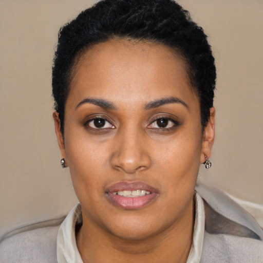 Joyful black young-adult female with short  black hair and brown eyes