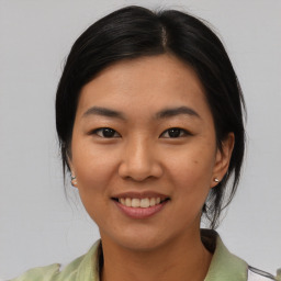 Joyful asian young-adult female with medium  black hair and brown eyes