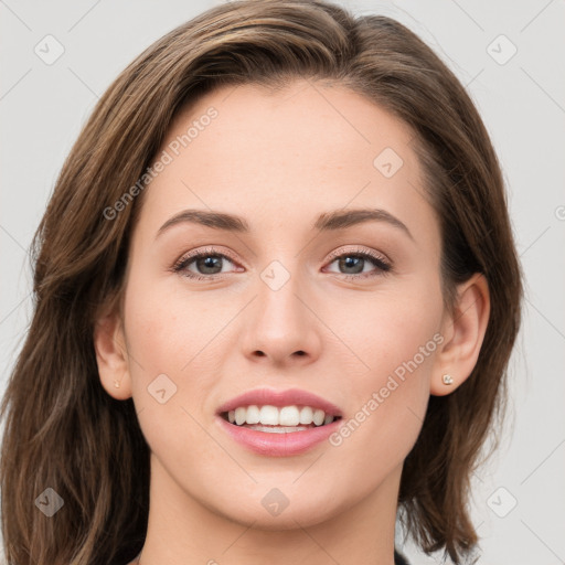 Joyful white young-adult female with long  brown hair and grey eyes