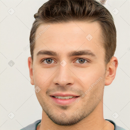 Joyful white young-adult male with short  brown hair and brown eyes