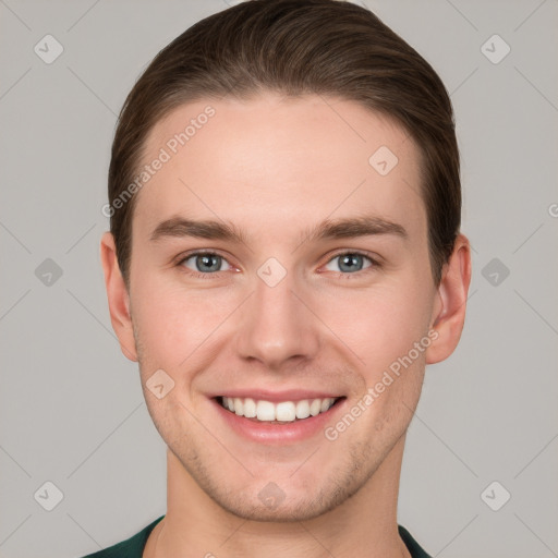 Joyful white young-adult male with short  brown hair and grey eyes