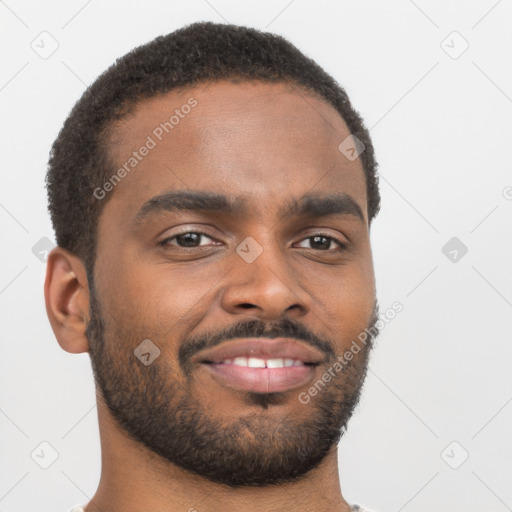 Joyful black young-adult male with short  brown hair and brown eyes