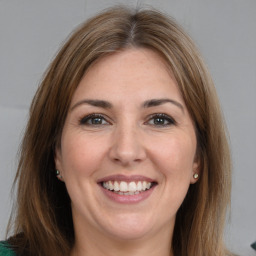 Joyful white young-adult female with medium  brown hair and green eyes