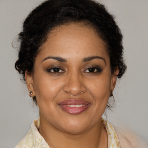 Joyful latino adult female with medium  brown hair and brown eyes