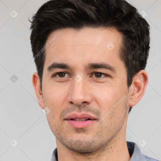 Joyful white young-adult male with short  black hair and brown eyes