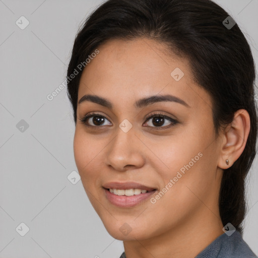 Joyful latino young-adult female with long  brown hair and brown eyes