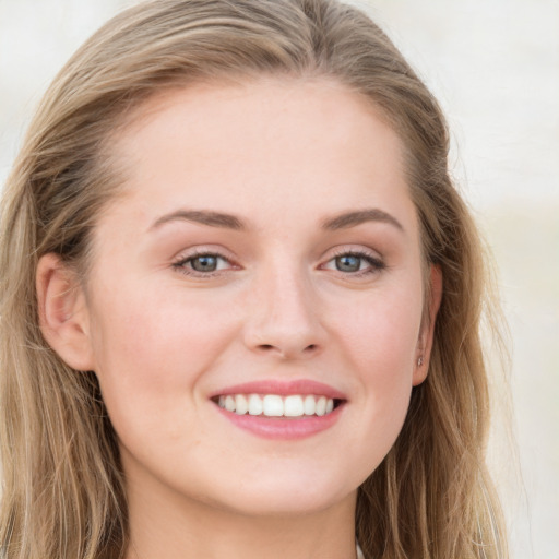 Joyful white young-adult female with long  brown hair and blue eyes