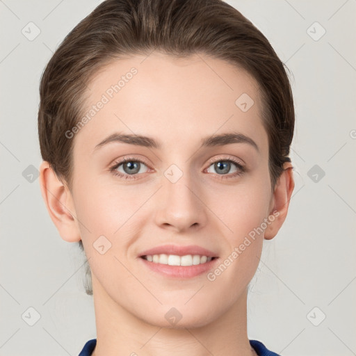 Joyful white young-adult female with short  brown hair and grey eyes