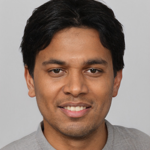 Joyful asian young-adult male with short  black hair and brown eyes
