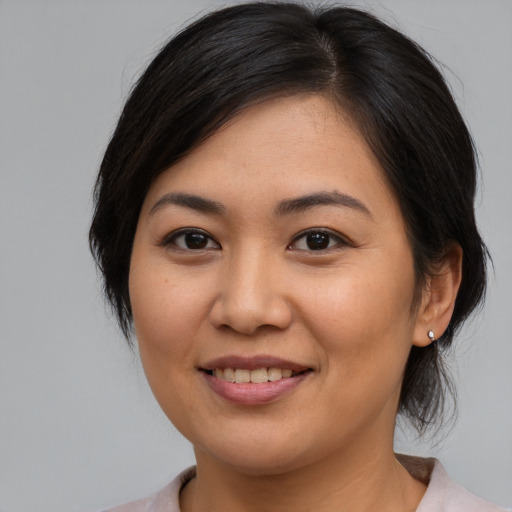 Joyful asian young-adult female with medium  brown hair and brown eyes