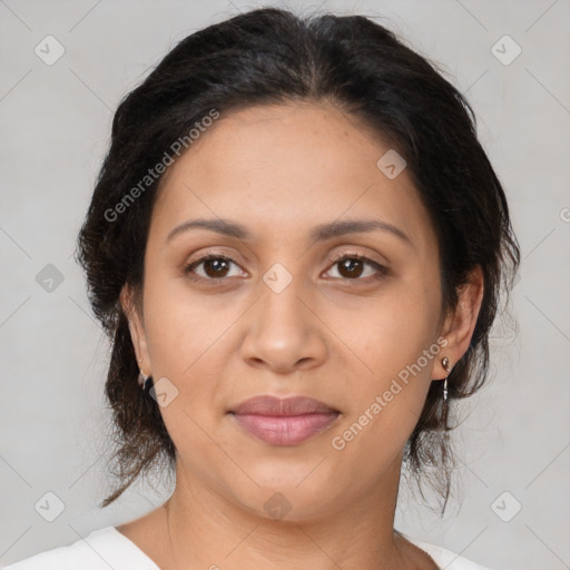 Joyful latino adult female with medium  brown hair and brown eyes