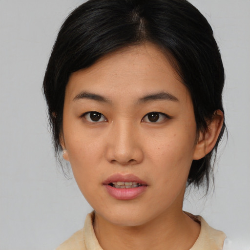 Joyful asian young-adult female with medium  black hair and brown eyes