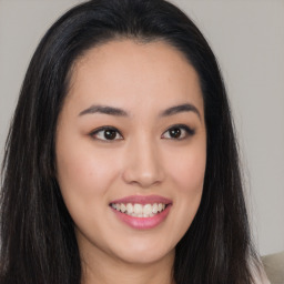 Joyful asian young-adult female with long  brown hair and brown eyes